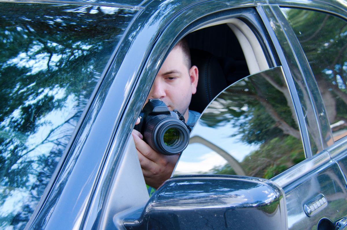 Private investigator conducting surveillance from a vehicle